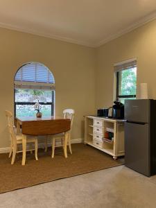 a kitchen with a table and a table and a refrigerator at Paradise Found - Private Oasis with Heated Pool on Marco Island in Marco Island