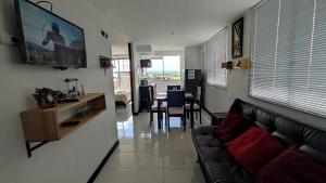 a living room with a couch and a dining room at Apartamento turistico cerca al parque del café en Montenegro Quindío in Montenegro