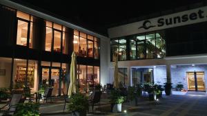 a building with a patio with chairs and a umbrella at Apartament Marzanna w Willi na Klifie in Rewal