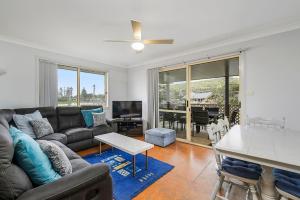 a living room with a couch and a table at Bellhaven 1, 17 Willow Street in Crescent Head