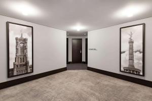 a hallway with three framed pictures of the tower and big ben at Radisson Collection Hotel, Berlin in Berlin