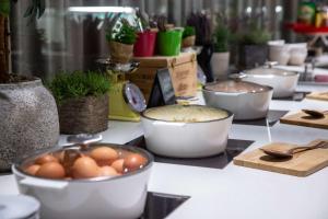 a table topped with pots and pans filled with plants at Radisson Blu, Basel in Basel