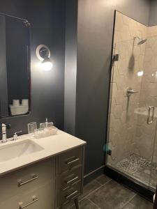 a bathroom with a sink and a shower at City Loft Escape with River Views! By Hollyhock in Louisville +26 photos