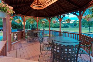 a deck with a table and chairs and a gazebo at Sonesta Simply Suites Nanuet in Nanuet