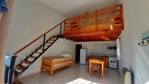 a kitchen with a spiral staircase in a room at Navarro Departamentos Temporarios in Navarro