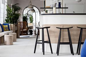 a kitchen with two black stools in front of a counter at Le Riviera Collection, Signature Collection by Best Western in Nice