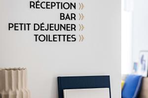 a sign on a wall that reads reception bar pet customer toilets at Le Riviera Collection, Signature Collection by Best Western in Nice