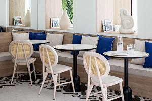a restaurant with two tables and two chairs at Le Riviera Collection, Signature Collection by Best Western in Nice