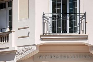 a white building with a window and a balcony at Le Riviera Collection, Signature Collection by Best Western in Nice