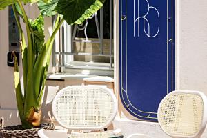 two white chairs sitting in front of a blue door at Le Riviera Collection, Signature Collection by Best Western in Nice