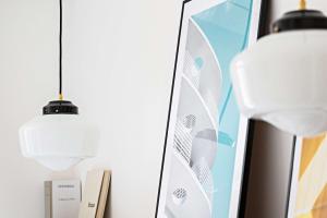 a wall with two pendant lights and a surfboard at Le Riviera Collection, Signature Collection by Best Western in Nice