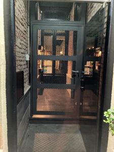 uma porta de vidro com um portão de metal em HOTEL COMERCIO PLAYA em Montevidéu