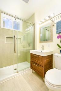 a bathroom with a shower and a toilet and a sink at Pali Kai Cottage 17 A, Ocean Bluff, Nawiliwili in Lihue