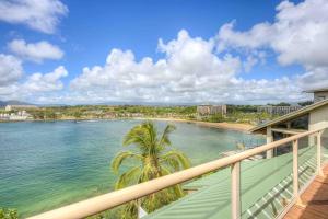 a balcony with a view of the ocean and a beach at Pali Kai Cottage 17 A, Ocean Bluff, Nawiliwili in Lihue