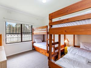 two bunk beds in a room with a window at Southern Tides in Port Fairy