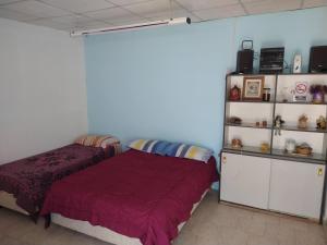 a bedroom with a bed and a book shelf at Departamentos Fuentes in Cipolletti