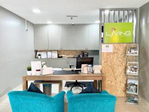an office with a desk and two blue chairs at Hotel Living at Dsulaiman Near to Kampung Baru, Chow Kit, Kuala Lumpur in Kuala Lumpur
