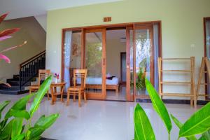 a room with a table and chairs and a bedroom at Puri Canggu Rooms 2 in Canggu