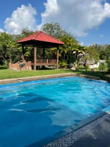 a large swimming pool with a gazebo at Villa Mommy A Famosa Resort in Malacca