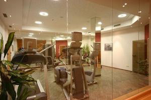 a gym with a bunch of treadms and mirrors at Hotel Herzblut - Joker card included in summer in Saalbach-Hinterglemm