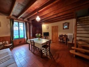 a living room with a table and a couch at Gîte Benet, 5 pièces, 8 personnes - FR-1-426-146 in Benet