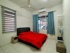 a bedroom with a red bed and a window at Zaara Homestay Krubong Alor Gajah Ayer Keroh Melaka in Melaka
