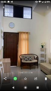 a living room with a couch and a window at Vila Bandungan in Bandungan