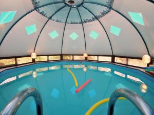 a swimming pool inside of a dome with a swimming pool at The Galilee Cabin in Arbel