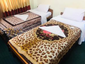 Postel nebo postele na pokoji v ubytování Hotel Green Orchid