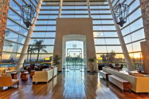 a lobby of a building with large windows at Sheraton Colonia Golf & Spa Resort in Colonia del Sacramento