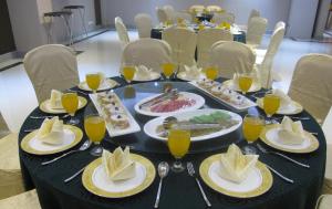 a black table with plates of food on it at Seri Simanggang Hotel in Simanggang