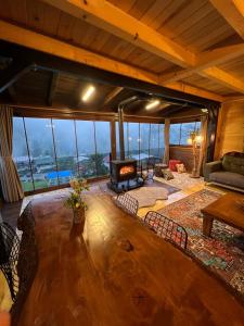 a living room with a couch and a fireplace at Ayder Villa Babil in Ayder Yaylasi