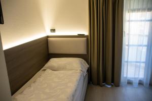 Postel nebo postele na pokoji v ubytování Hotel Garnì Villa Fontana