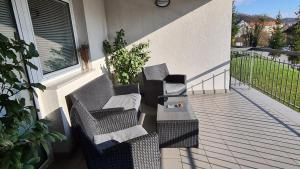 two chairs and a table on a balcony at Apartmani Sanja in Krapinske Toplice