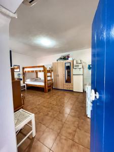 a room with a kitchen and a bedroom with a bunk bed at Sea View Studio Armenistis Ikarias in Armenistis