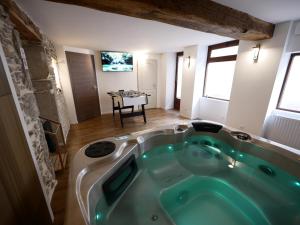 a bath tub in the middle of a room at Gîte de Crémieu - gitesdesbalcons-com in Crémieu