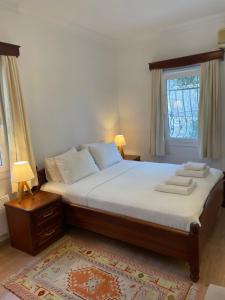 a bedroom with a bed with two towels on it at Beach House With Direct Access to Private Beach Near Bodrum in Çamlık