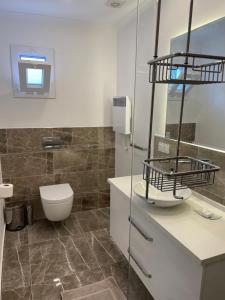 a bathroom with a toilet and a sink at Beach House With Direct Access to Private Beach Near Bodrum in Çamlık +28 photos