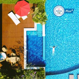 an overhead view of a person standing in a swimming pool at Avani+ Hua Hin Resort in Cha Am