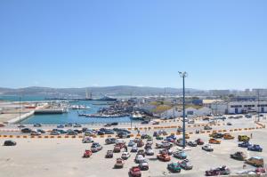 a beach filled with lots of boats and people at Hotel Continental in Tangier
