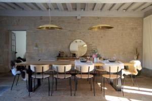 a dining room with a table and chairs and a mirror at La SAURA in Lusigny-sur-Ouche