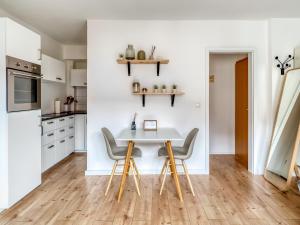 a kitchen with a white table and chairs at limehome Kassel Motzstraße in Kassel