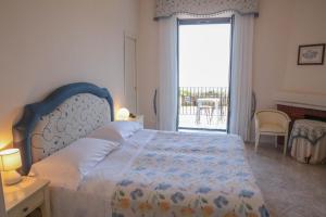 Ένα ή περισσότερα κρεβάτια σε δωμάτιο στο Hotel La Badia