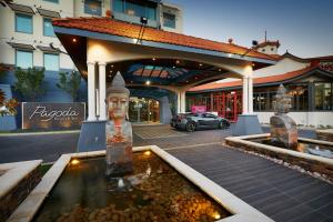a building with a fountain with two statues in front of it at Pagoda Resort & Spa in Perth