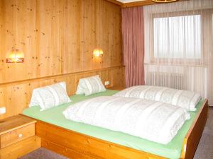 sypialnia z dużym łóżkiem i drewnianymi ścianami w obiekcie Holiday Home Kainer by Interhome w mieście Strass im Zillertal