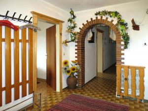 a hallway with an archway and a vase of flowers at Apartment Höllwarth by Interhome in Fügenberg
