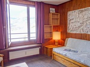 a bedroom with a window and a bed with a lamp at Studio Les Moutières B1 et B2-8 by Interhome in Tignes