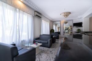 a living room with two blue couches and a table at Hotel La Pergola in Sant'Agnello