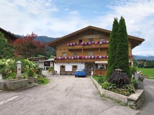 a house with a blue car parked in front of it at Apartment Punggerhof - KAB100 by Interhome in Kaltenbach