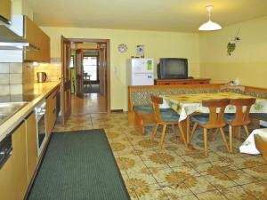 a kitchen and dining room with a table and chairs at Apartment Punggerhof - KAB100 by Interhome in Kaltenbach